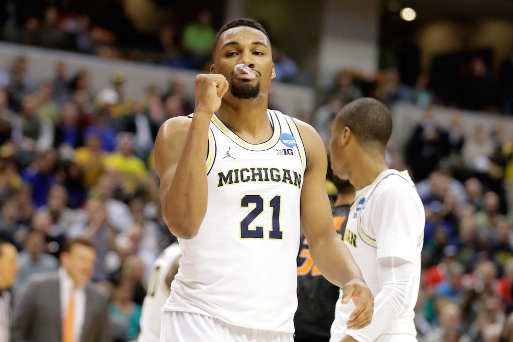 Michigan's Zak Irvin #21 pumps his fist.