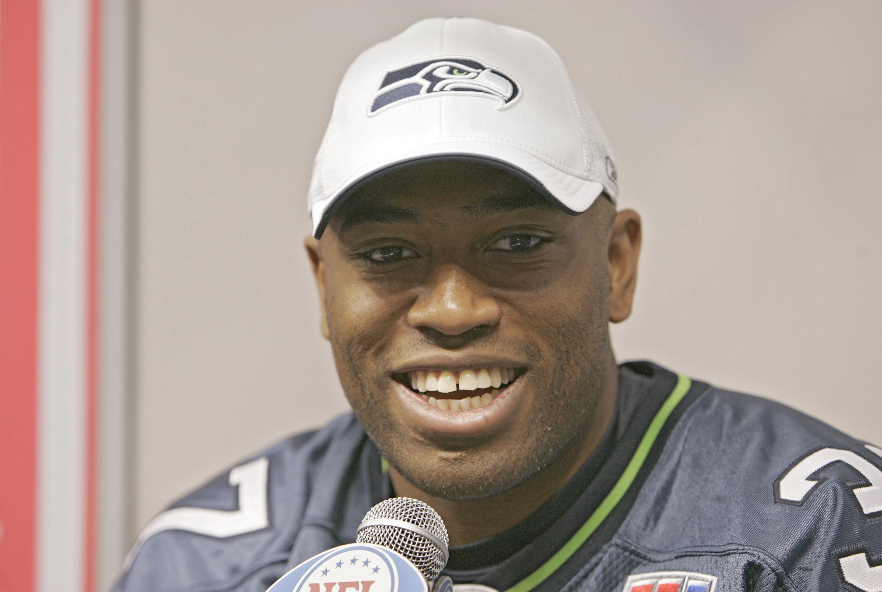 Shaun Alexander talks during a media conference.