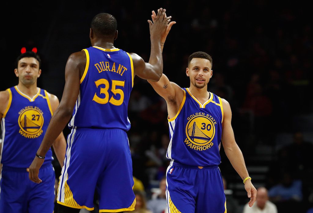 Stephen Curry #30 of the Golden State Warriors celebrates a second half basket with Kevin Durant #35