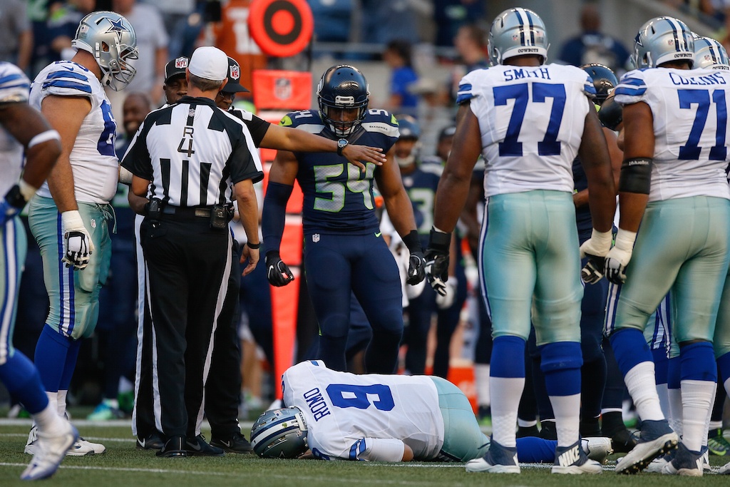 Tony Romo lies on the turf after getting injured.