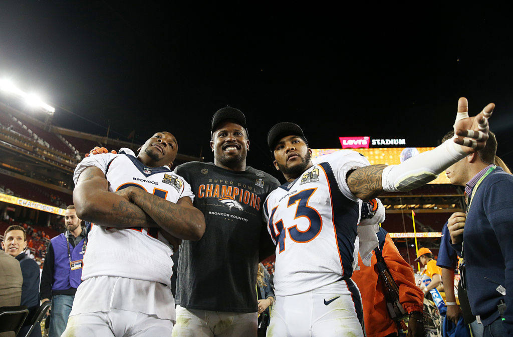 Aqib Talib, Von Miller, and T.J. Ward of the Denver Broncos celebrate winning Super Bowl 50.