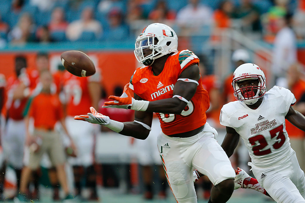 David Njoku of the Miami Hurricanes holds his hands out to catch the football.