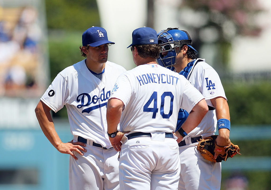 Pitching coach Rick Honeycutt goes to the mound to talk to his pitcher.