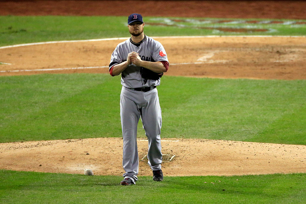 Jon Lester of the Boston Red Sox holds his arm as he is removed from Game 5 of the 2013 World Series.