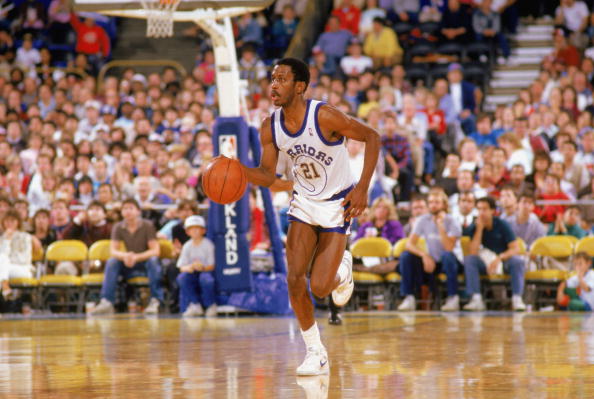 Eric "Sleepy" Floyd of the Golden State Warriors drives up court.