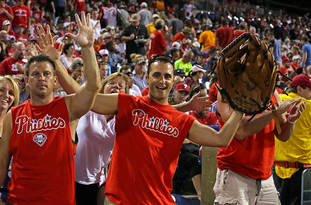 A Philadelphia Phillies fan shows off his oversized baseball glove. 