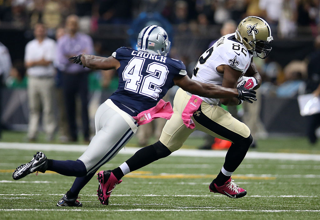 Benjamin Watson of the New Orleans Saints carries the ball as Barry Church of the Dallas Cowboys defends.