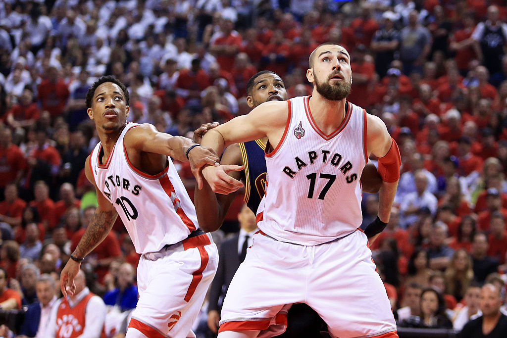 Jonas Valanciunas and DeMar DeRozan of the Toronto Raptors look to rebound against Tristan Thompson of the Cleveland Cavaliers.