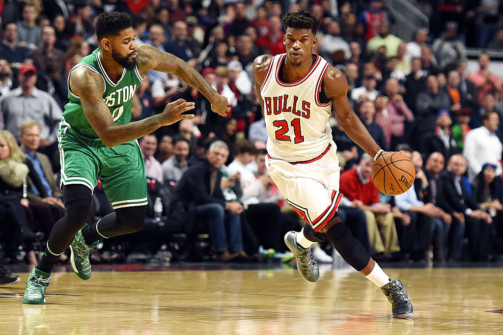 Jimmy Butler of the Chicago Bulls drives to the basket against Amir Johnson of the Boston Celtics.