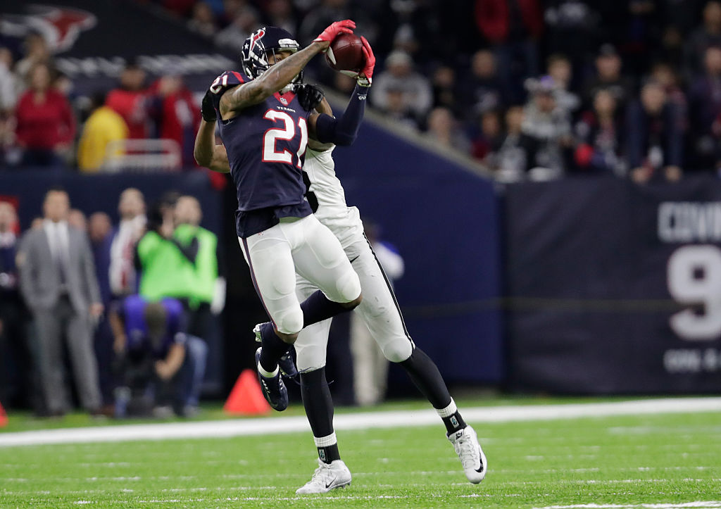 A.J. Bouye of the Houston Texans intercepts a pass from Connor Cook of the Oakland Raiders