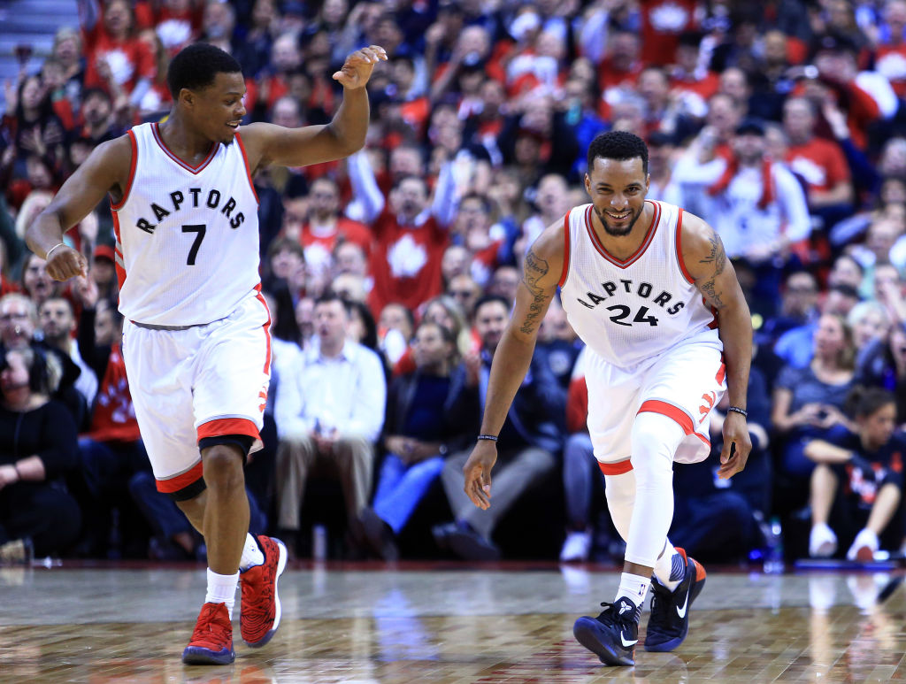 Norman Powell of the Toronto Raptors celebrates a dunk with Kyle Lowry.