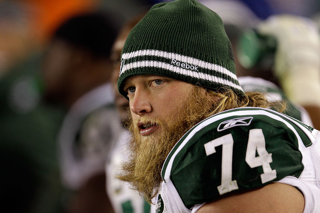 Nick Mangold of the New York Jets looks on from the sidelines. 