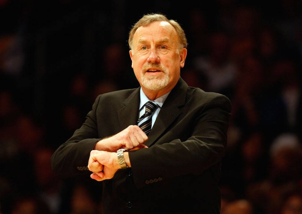 Rick Adelman gestures to the referee.