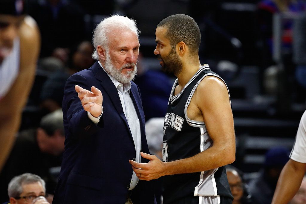Head coach Gregg Popovic of the San Antonio Spurs talks to Tony Parker.