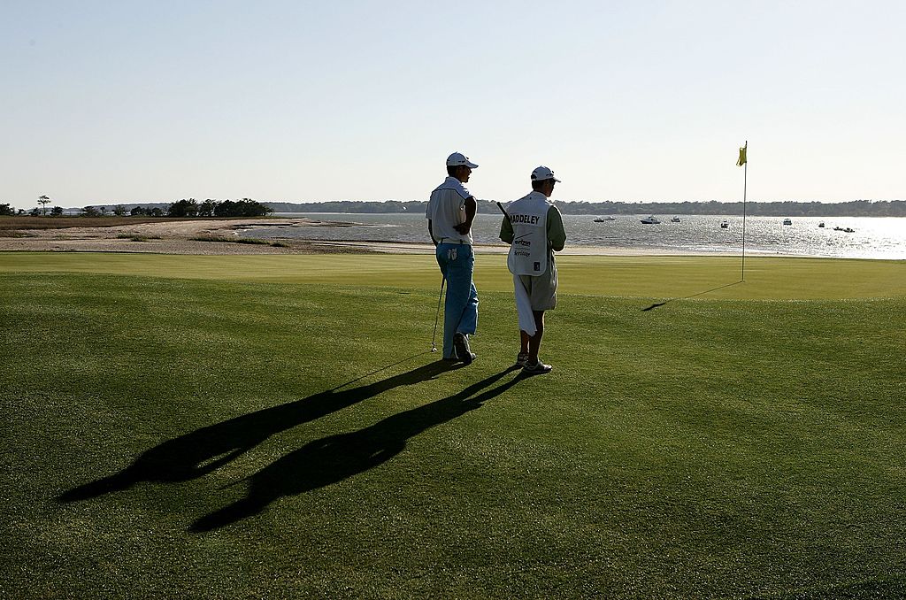 Aaron Baddeley of Australia and his caddie Kenny Harms watch on at the 18th hole during the third round.