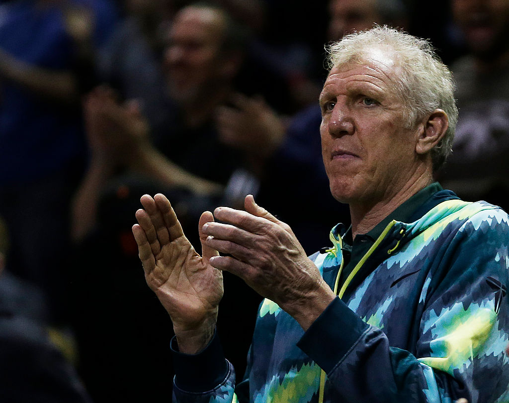 Bill Walton applauds during a basketball game.
