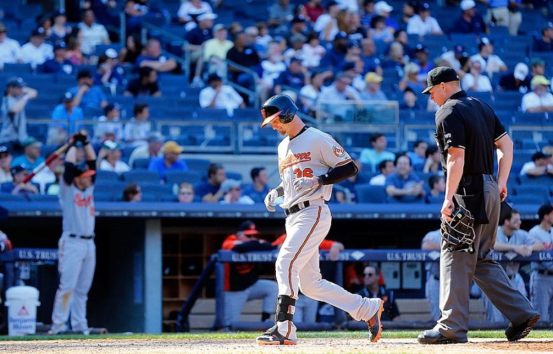 Caleb Joseph of the Baltimore Orioles touches home plate after his home run at Yankee Stadium.