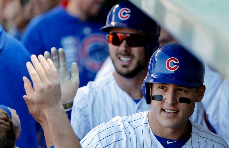 Chicago Cubs third baseman Kris Bryant (center) and first baseman Anthony Rizzo Shot of Chicago Cubs Anthony Rizzo and Kris Bryant in the dugout