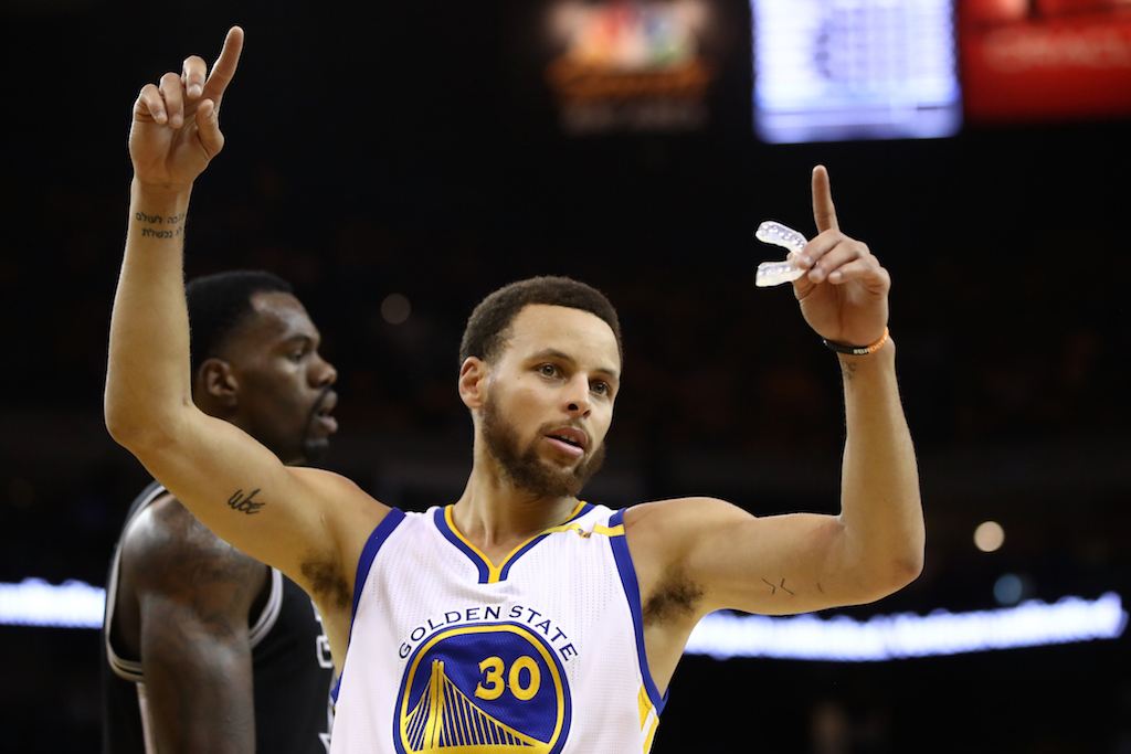 Stephen Curry signals after a play.