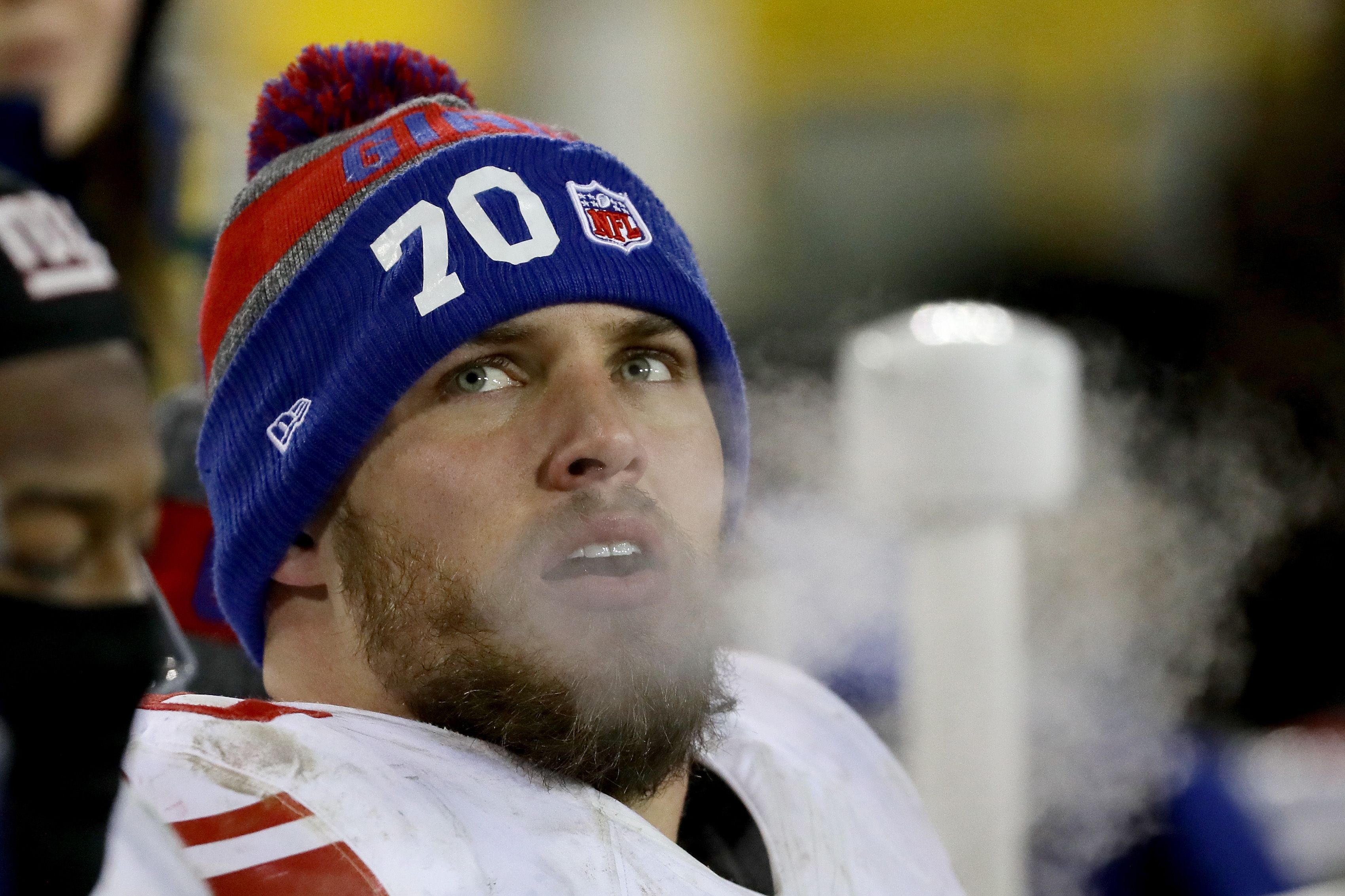 Weston Richburg rests on the sidelines during a game.
