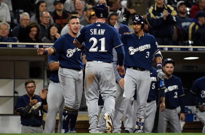Travis Shaw of the Milwaukee Brewers is congratulated after scoring.