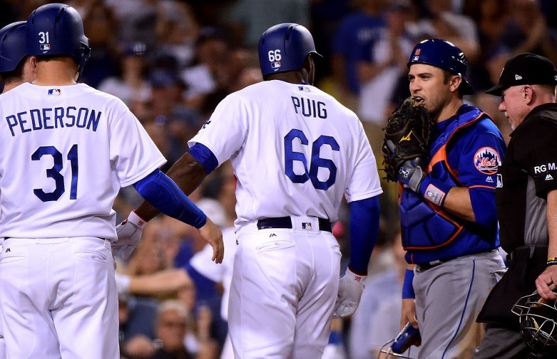 Travid d'Arnaud engages Yasiel Puig at home plate at Dodger Stadium.