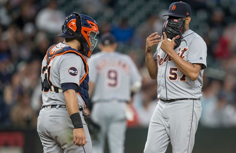 Catcher Alex Avila and relief pitcher Francisco Rodriguez of the Detroit Tigers meet at the pitcher's mound.