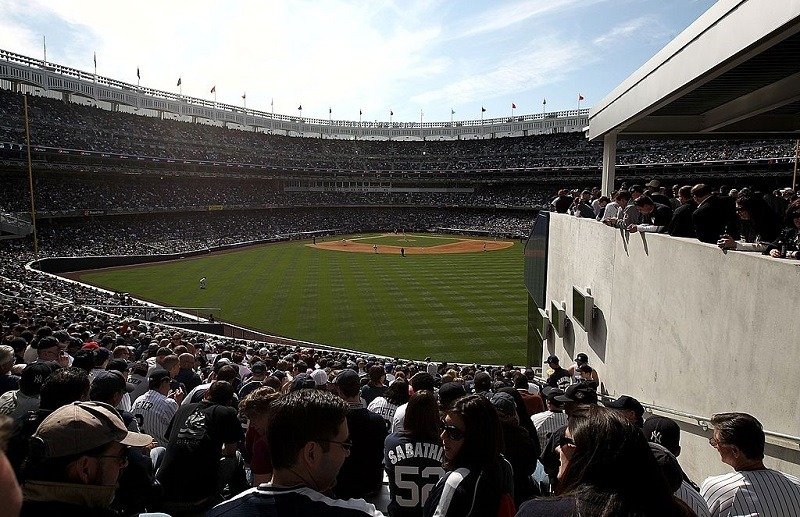 Fans sit in the obstructed view seats in the bleachers at new Yankee Stadium on April 16, 2009.