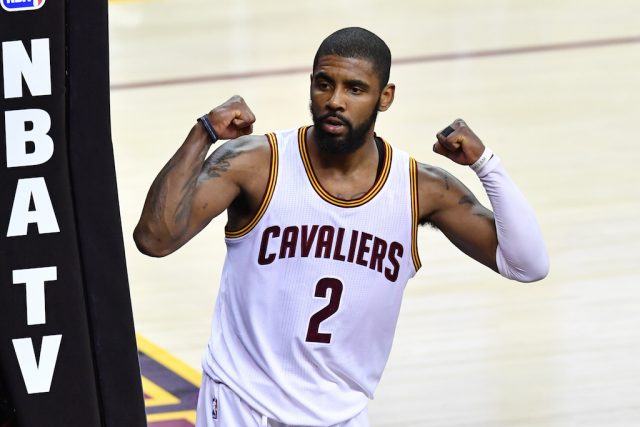 Kyrie Irving flexes his muscles. Kyrie Irving flexes his muscles.