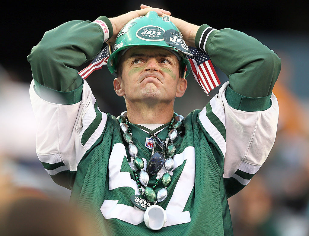 A New York Jets fans watches the final minutes of a game against the Miami Dolphins.