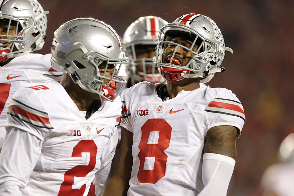 Gareon Conley of the Ohio State Buckeyes laughs with his teammate.