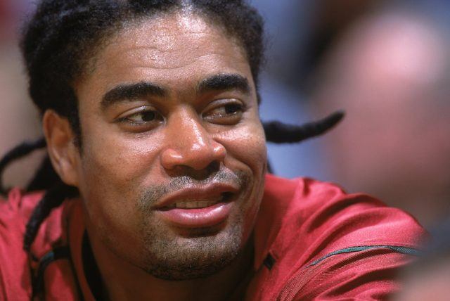 Pervis Ellison looks on from the bench.