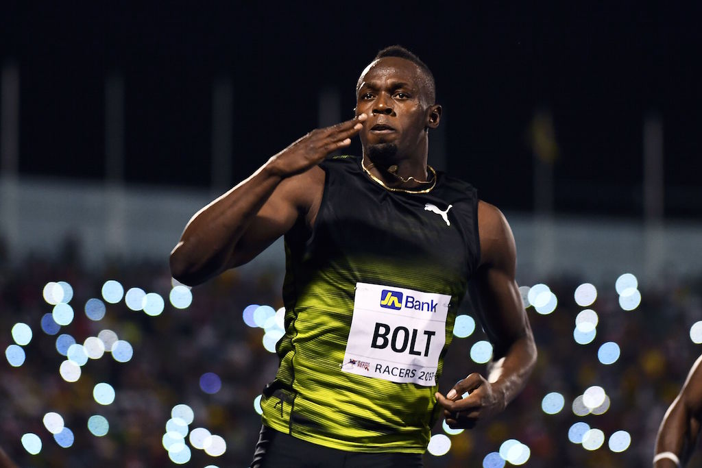 Usain Bolt crosses the finish line.