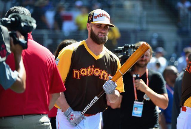 Bryce Harper looks on during workouts.