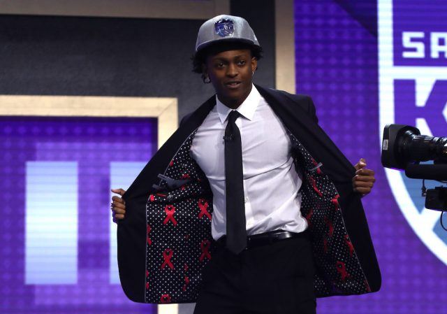 De'Aaron Fox walks across the stage at the 2017 NBA Draft. De'Aaron Fox is drafted by the Kings.