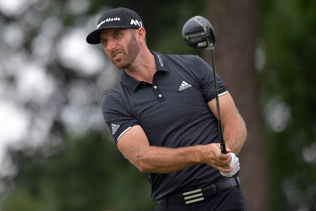 Dustin Johnson follows his ball after a shot. Dustin Johnson watches his shot.