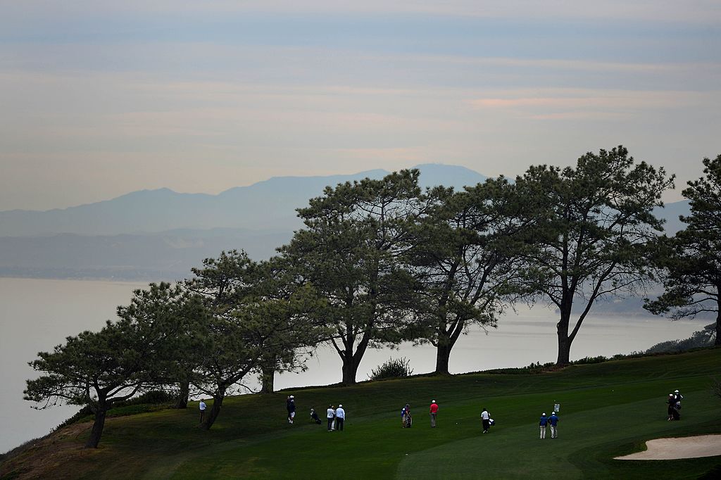 Golfers walk across Torrey Pines Golf Course in La Jolla, California before the Farmers Insurance Open.