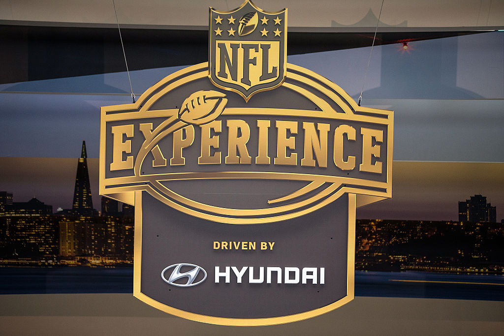 An NFL logo appears across the TV screen.