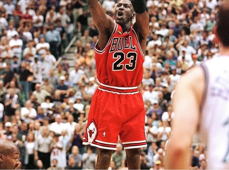 With 5.2 seconds left in the game, Michael Jordan of the Chicago Bulls aims and shoots the game-winning jump shot as Bryon Russell of the Utah Jazz drives at Jordan's feet.