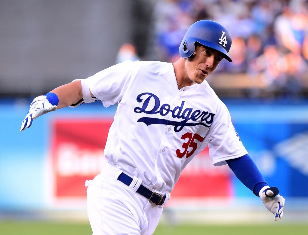 Cody Bellinger smiles as he runs in a home run.