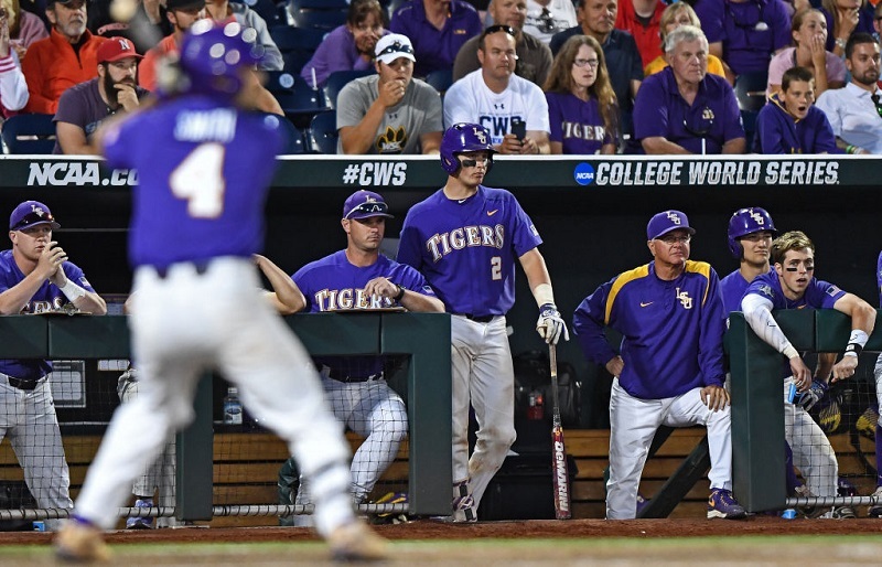 Head coach Paul Mainieri of the LSU Tigers looks on from the dugout.