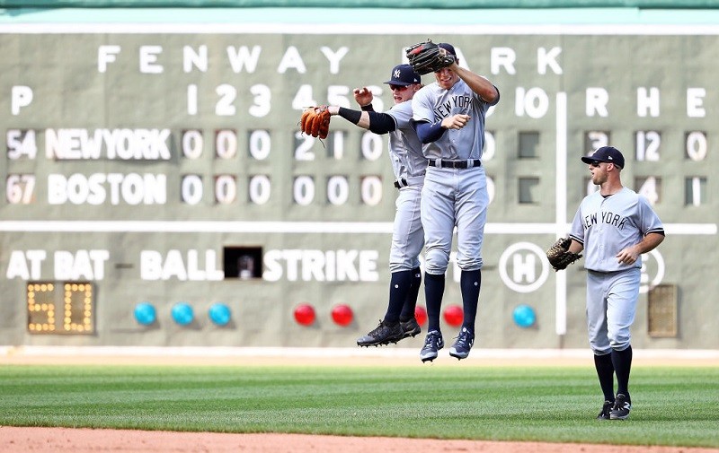 The New York Yankees celebrate an out at Fenway Park.