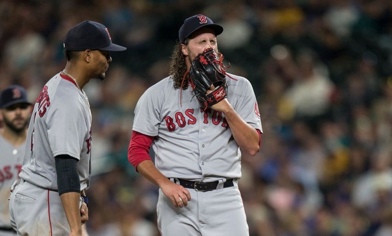 Relief pitcher Heath Hembree #37 of the Boston Red Sox reacts before getting pulled from a game.