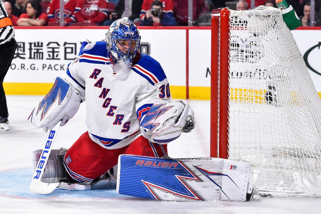 Henrik Lundqvist gloves the puck.