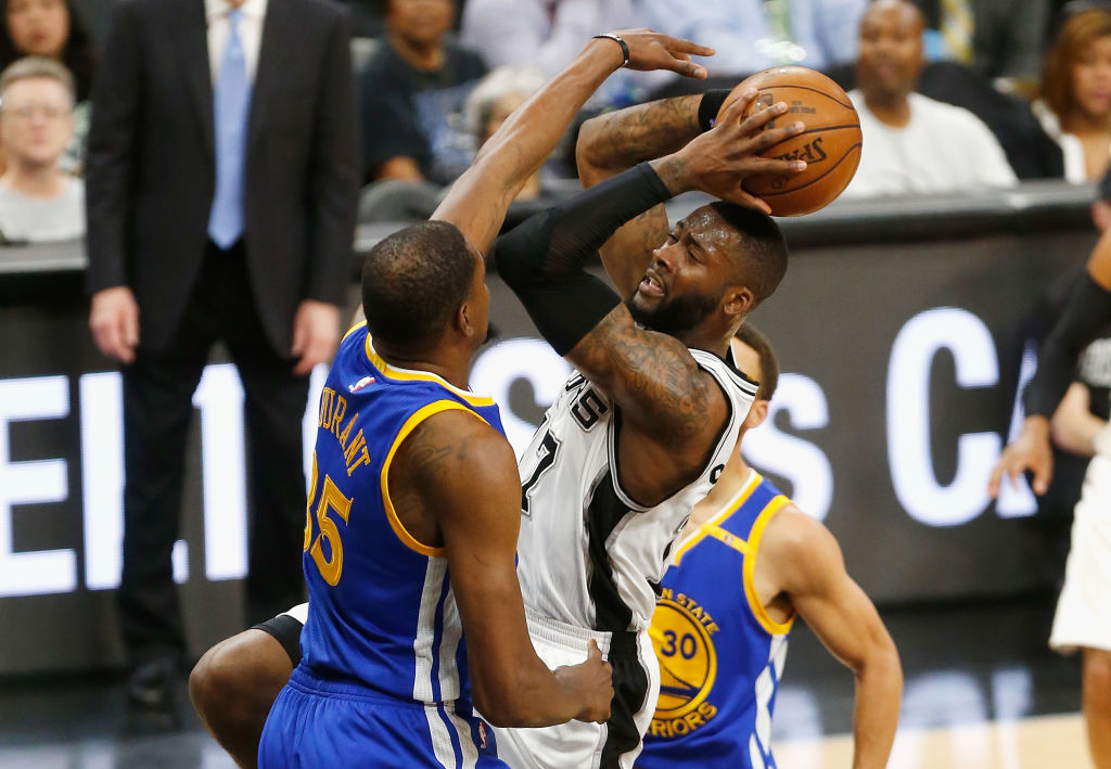 Jonathon Simmons of the San Antonio Spurs drives to the basket against Kevin Durant of the Golden State Warriors.
