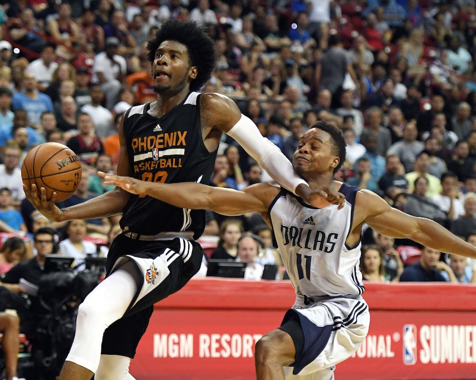 Josh Jackson gets ready to fly. Josh Jackson goes toward the bucket.