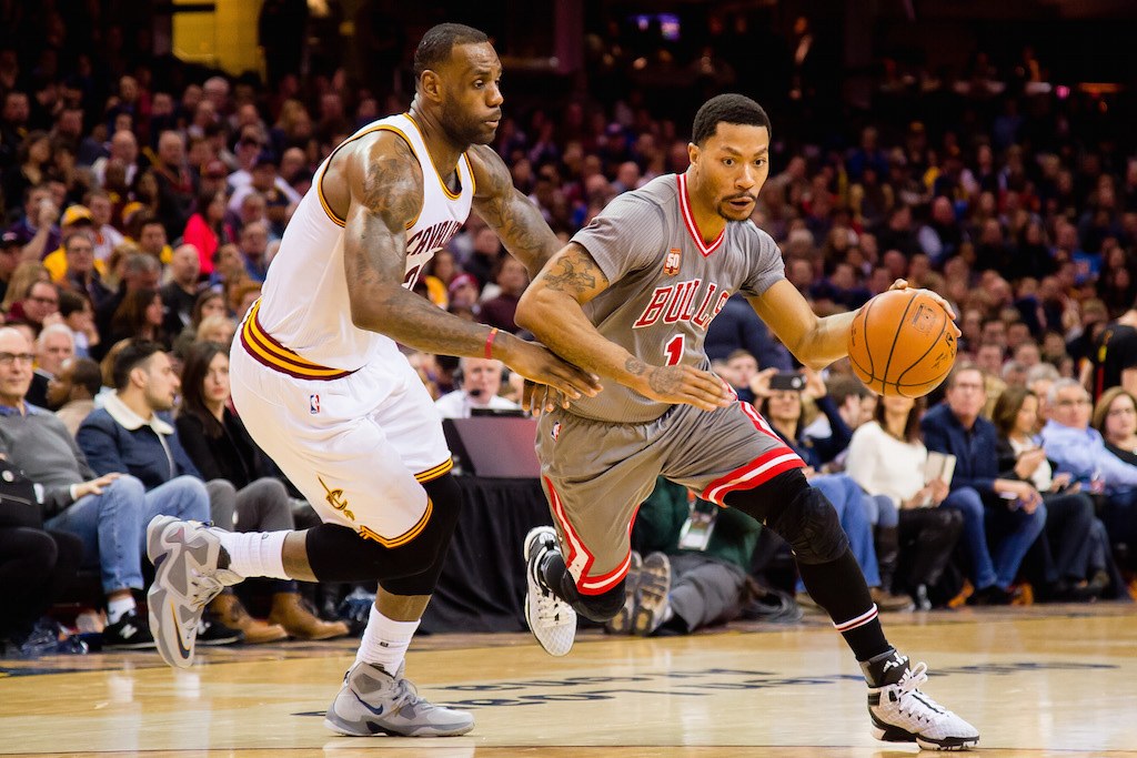 LeBron James (L) guards Derrick Rose. Derrick Rose drives on LeBron James.