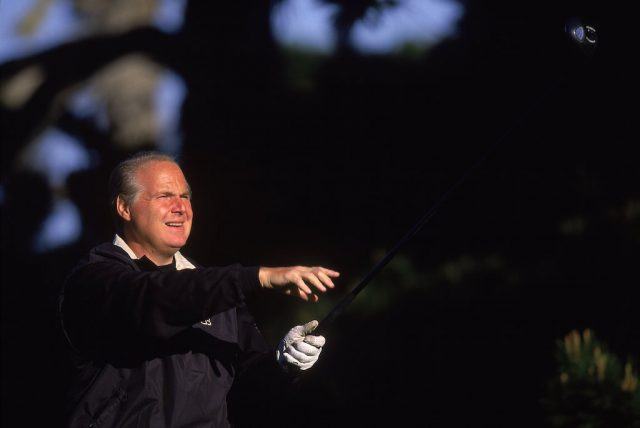 Rush Limbaugh looks on after teeing off.