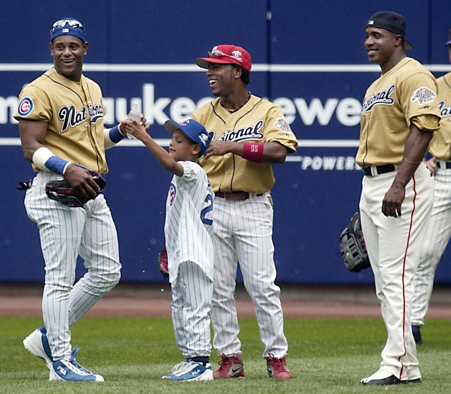 Sammy Sosa, Jimmy Rollins, and Barry Bonds look on during battle practice.