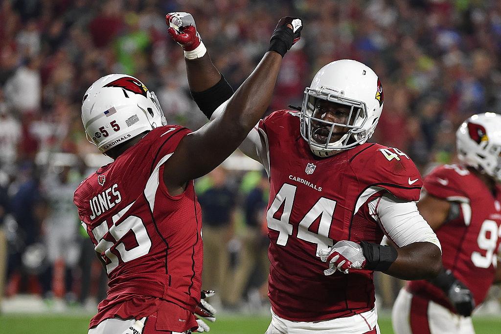 Outside linebackers Chandler Jones #55 and Markus Golden #44 of the Arizona Cardinals celebrate a touchdown.